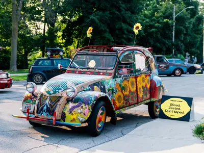 Old car with funky and bright painted designs all over it