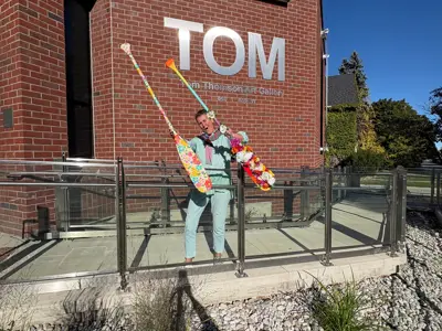 Local Artist Heather Travis holding Art Paddles