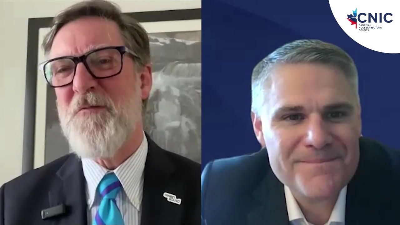 A screenshot of two men in blue suits, Mayor Ian Boddy and Bruce Power COO James Scongack, speaking to each other in a video podcast.