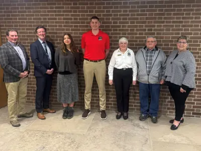 Volunteer of the Year award recipients standing in front of a brick wall