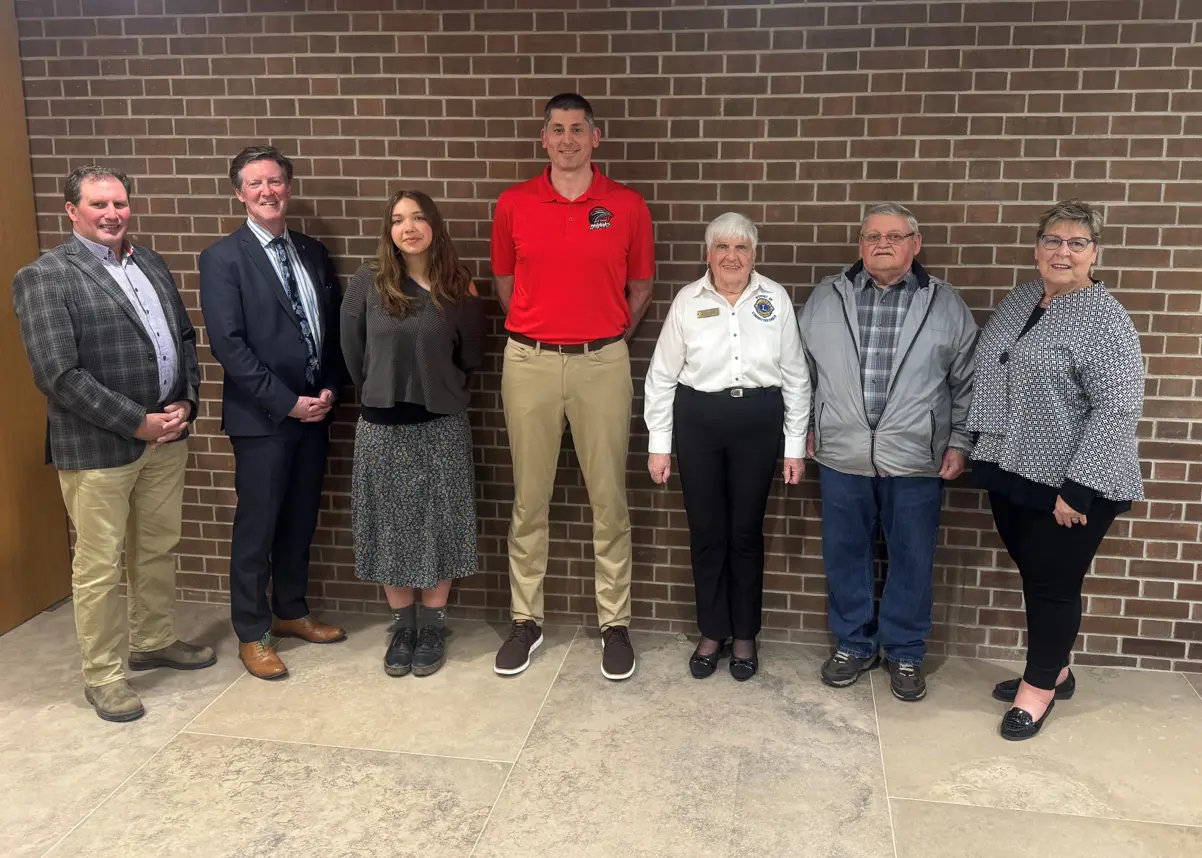 Volunteer of the Year award recipients standing in front of a brick wall
