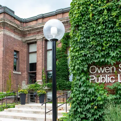 Outside of Public Library Building, brick building with vines on it
