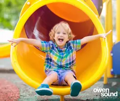 Young child at bottom of slide